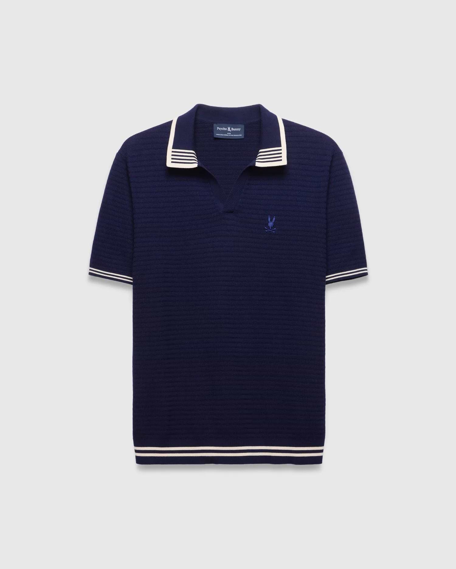 Mens Elowen Knit Polo in navy, featuring a textured knit fabric, white striped collar, cuffs, and hem, with a small embroidered Psycho Bunny skull logo on the left chest.