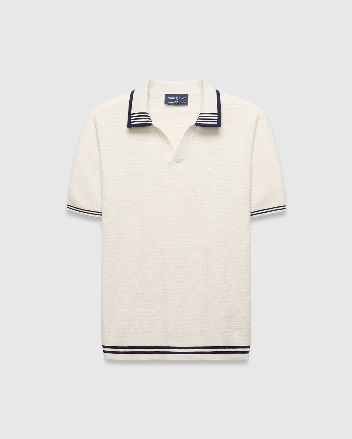 Mens Elowen Knit Polo, cream ribbed knit with navy striped V-neck collar, cuffs, and hem, featuring a small embroidered Psycho Bunny skull logo on the left chest.