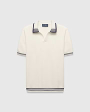 Mens Elowen Knit Polo, cream ribbed knit with navy striped V-neck collar, cuffs, and hem, featuring a small embroidered Psycho Bunny skull logo on the left chest.