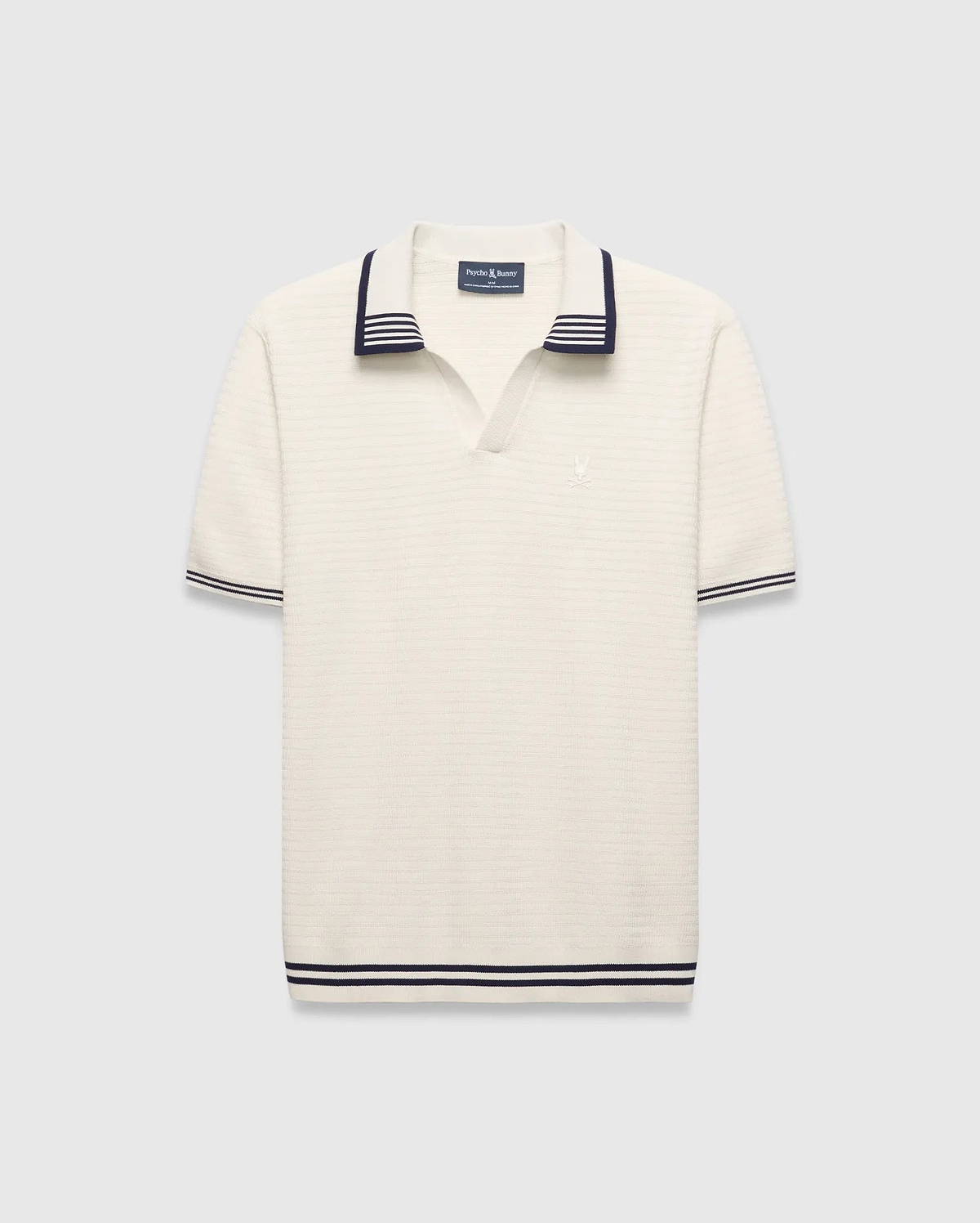 Mens Elowen Knit Polo, cream ribbed knit with navy striped V-neck collar, cuffs, and hem, featuring a small embroidered Psycho Bunny skull logo on the left chest.