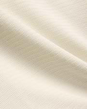 Mens Elowen Knit Polo in cream, showcasing a premium textured knit fabric with a fine horizontal rib pattern, embodying refined streetwear style.