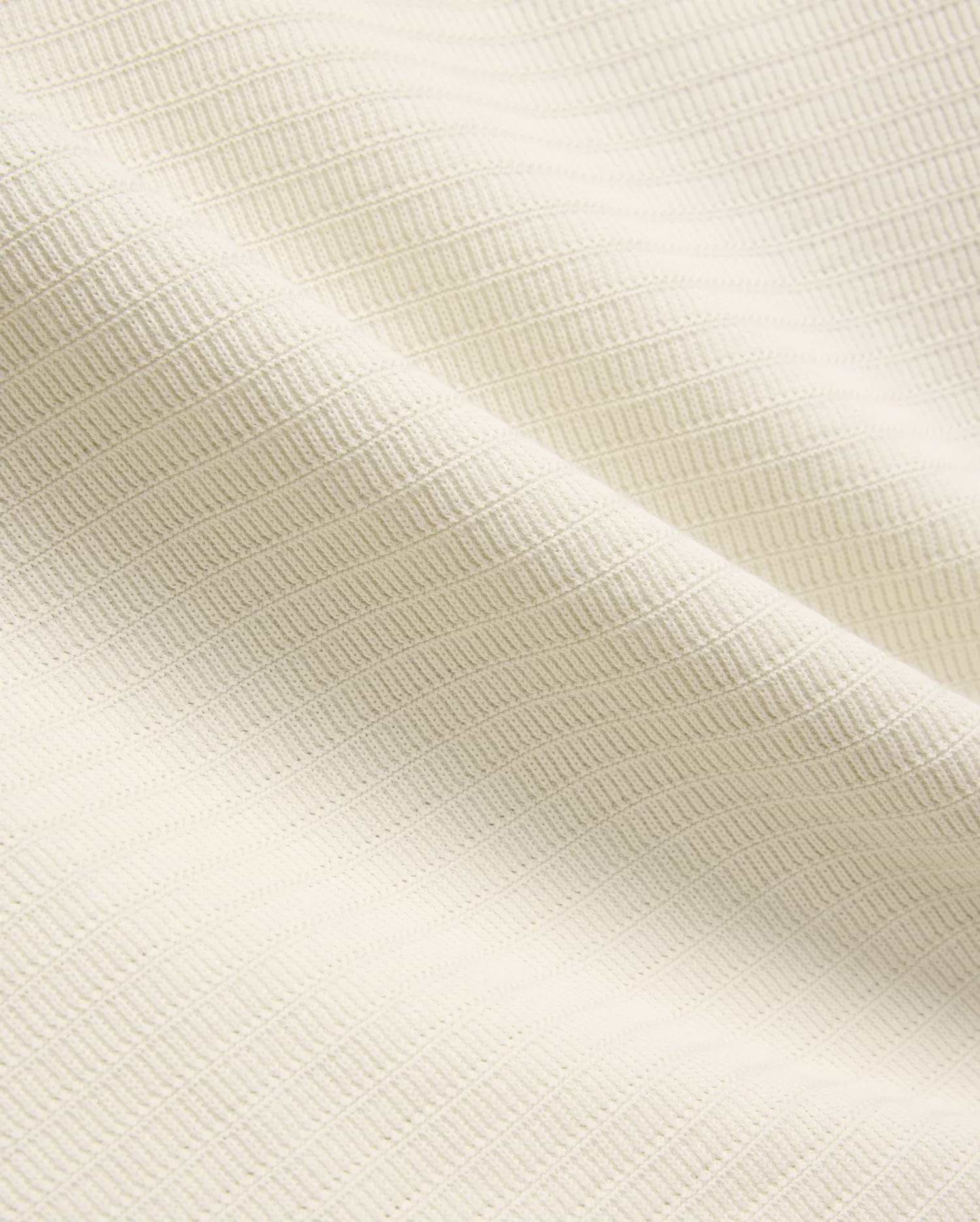 Mens Elowen Knit Polo in cream, showcasing a premium textured knit fabric with a fine horizontal rib pattern, embodying refined streetwear style.