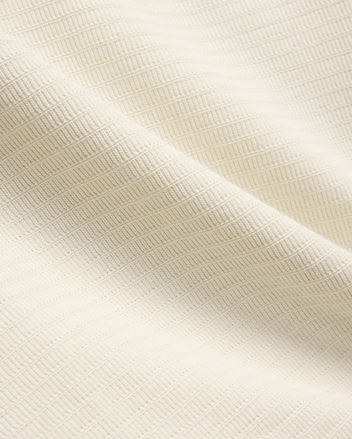 Mens Elowen Knit Polo in cream, showcasing a premium textured knit fabric with a fine horizontal rib pattern, embodying refined streetwear style.