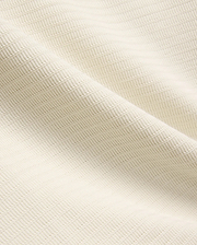 Mens Elowen Knit Polo in cream, showcasing a premium textured knit fabric with a fine horizontal rib pattern, embodying refined streetwear style.