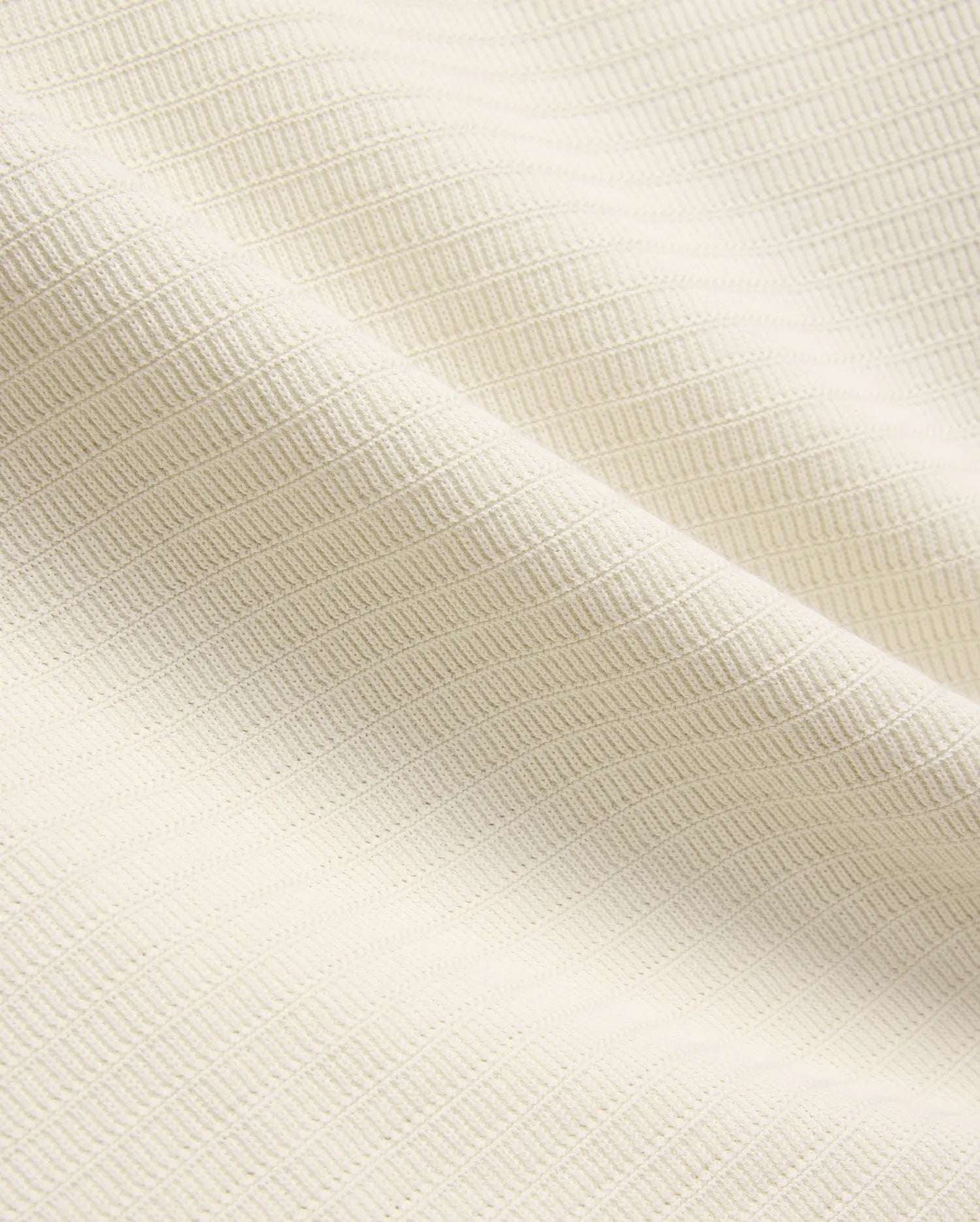 Mens Elowen Knit Polo in cream, showcasing a premium textured knit fabric with a fine horizontal rib pattern, embodying refined streetwear style.