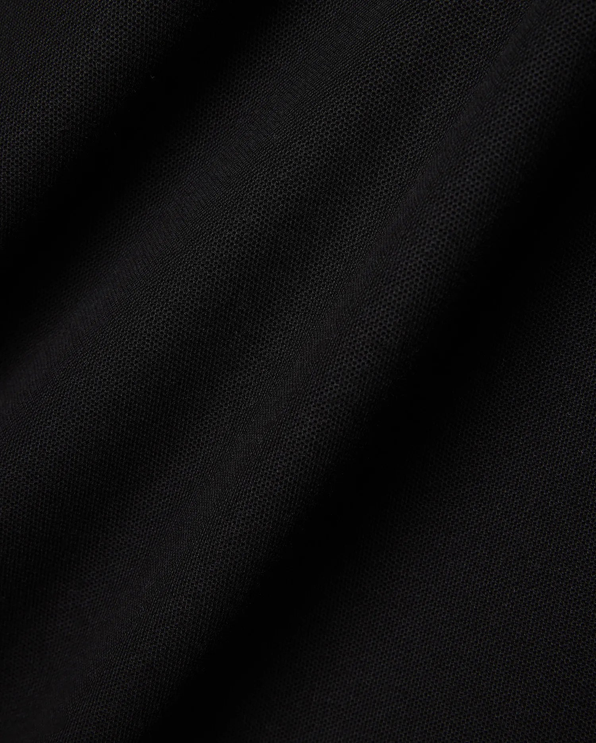 Mens Faye Pique Polo in a rich, deep black, showcasing the refined, breathable textured pique fabric with subtle folds and shadows, emphasizing its premium quality and classic weave.