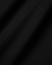 Mens Faye Pique Polo in a rich, deep black, showcasing the refined, breathable textured pique fabric with subtle folds and shadows, emphasizing its premium quality and classic weave.