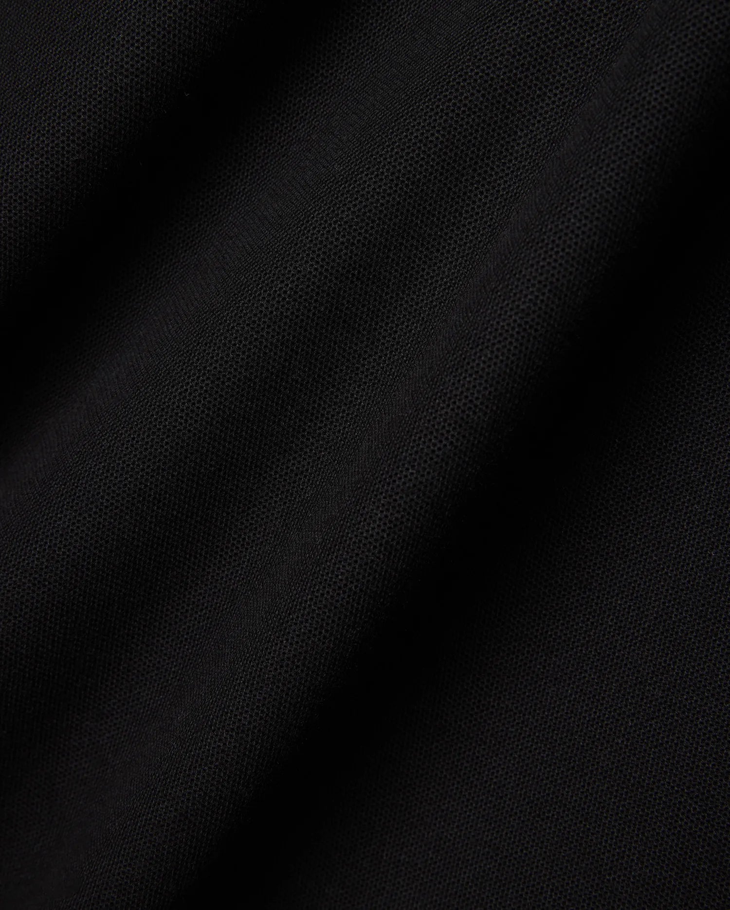 Mens Faye Pique Polo in a rich, deep black, showcasing the refined, breathable textured pique fabric with subtle folds and shadows, emphasizing its premium quality and classic weave.