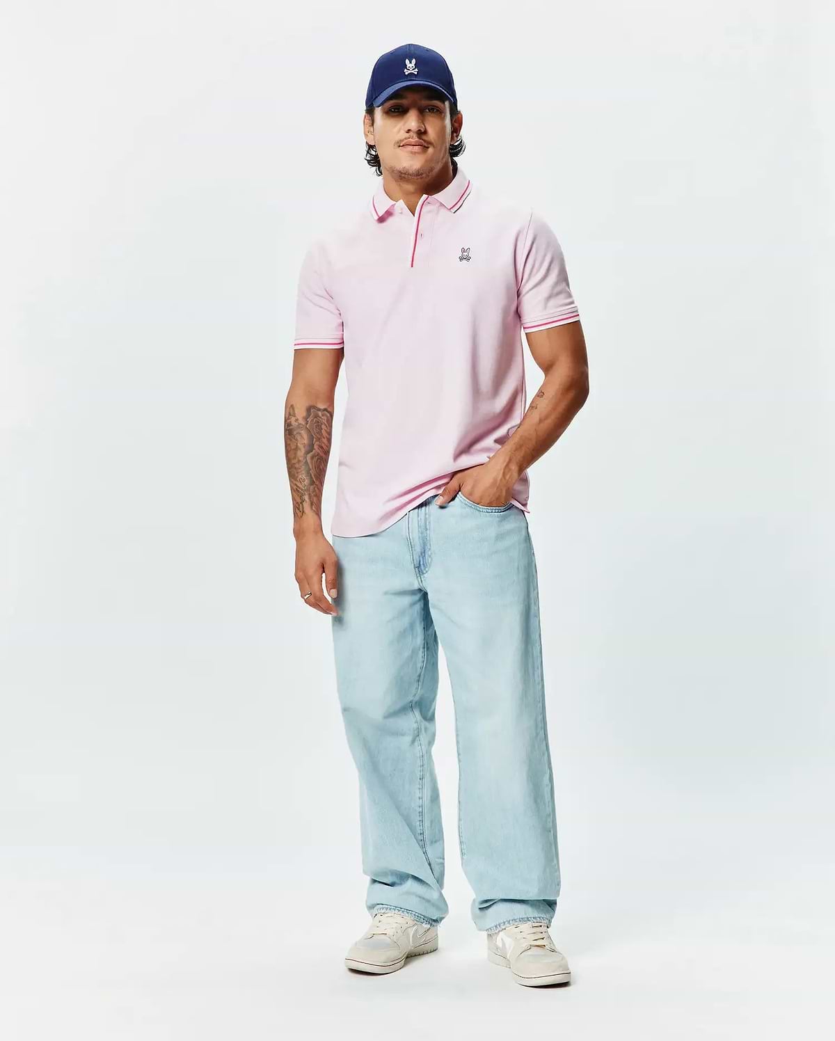 Mens Faye Pique Polo, a classic fit light pink pique knit polo with a small embroidered Psycho Bunny skull logo on the left chest and contrasting pink tipped collar and cuffs.
