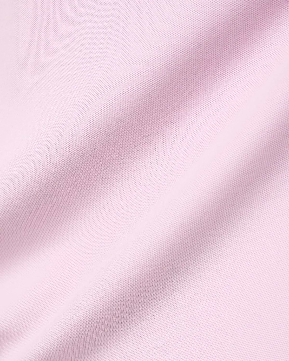 Mens Faye Pique Polo in a soft light pink, featuring a refined, classic pique knit fabric texture with gentle drapes, embodying premium Psycho Bunny style.