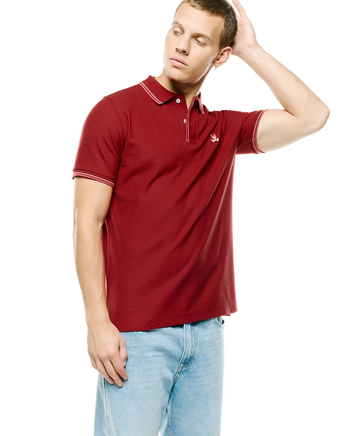 Men's Slade Pique Polo in deep red, featuring a classic fit, pique knit texture, white tipped collar and cuffs, and a small embroidered Psycho Bunny skull logo on the left chest. (3)