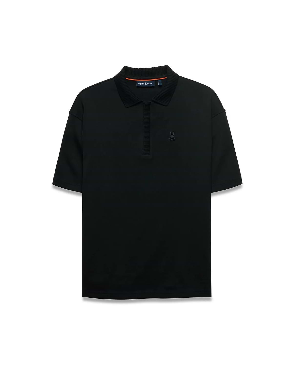 Men's Nolen Oversized Jersey Polo in black jersey fabric, featuring a ribbed collar and placket, with a small embroidered Psycho Bunny skull logo on the left chest and subtle orange accent on the inner collar. (5)