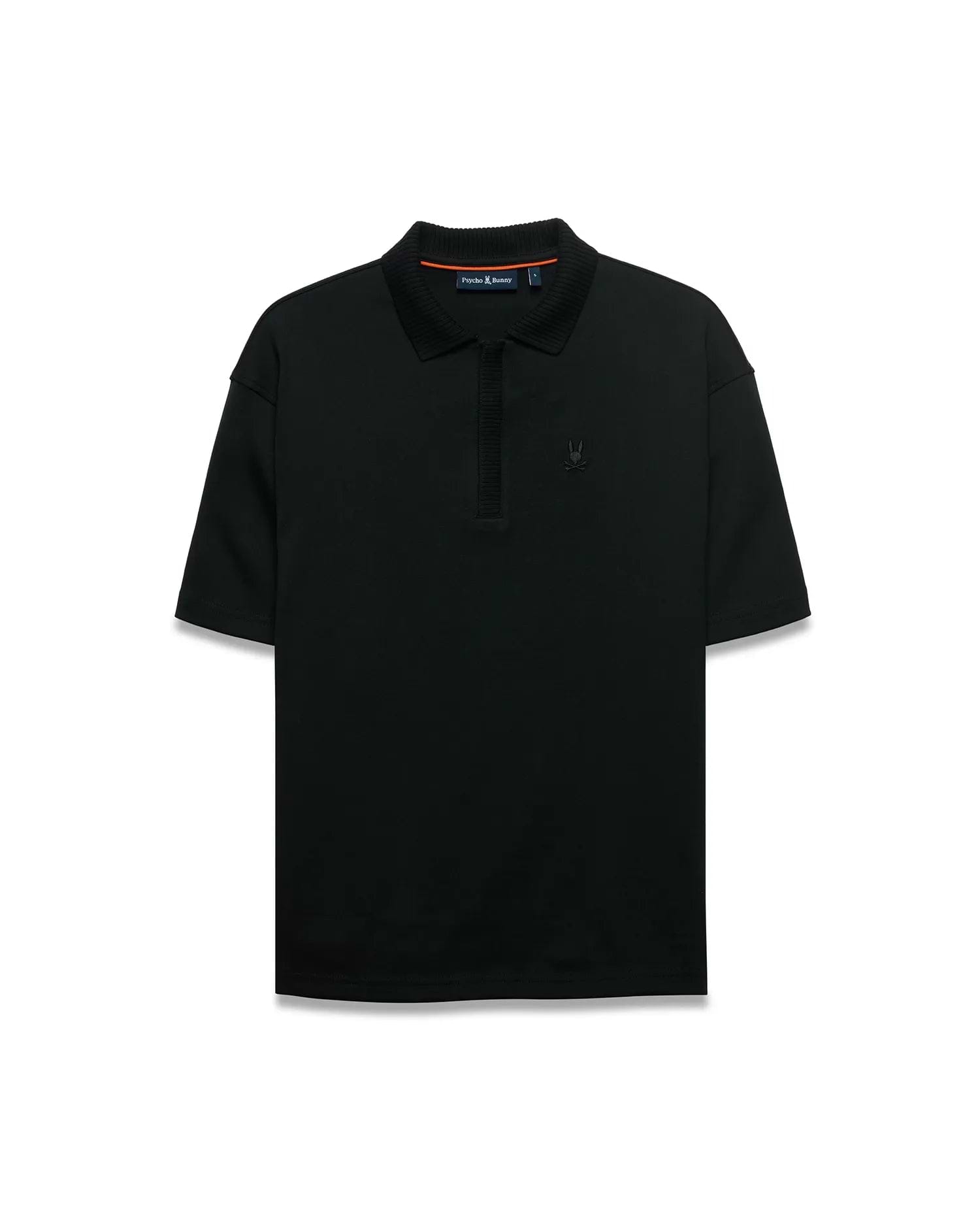 Men's Nolen Oversized Jersey Polo in black jersey fabric, featuring a ribbed collar and placket, with a small embroidered Psycho Bunny skull logo on the left chest and subtle orange accent on the inner collar. (5)