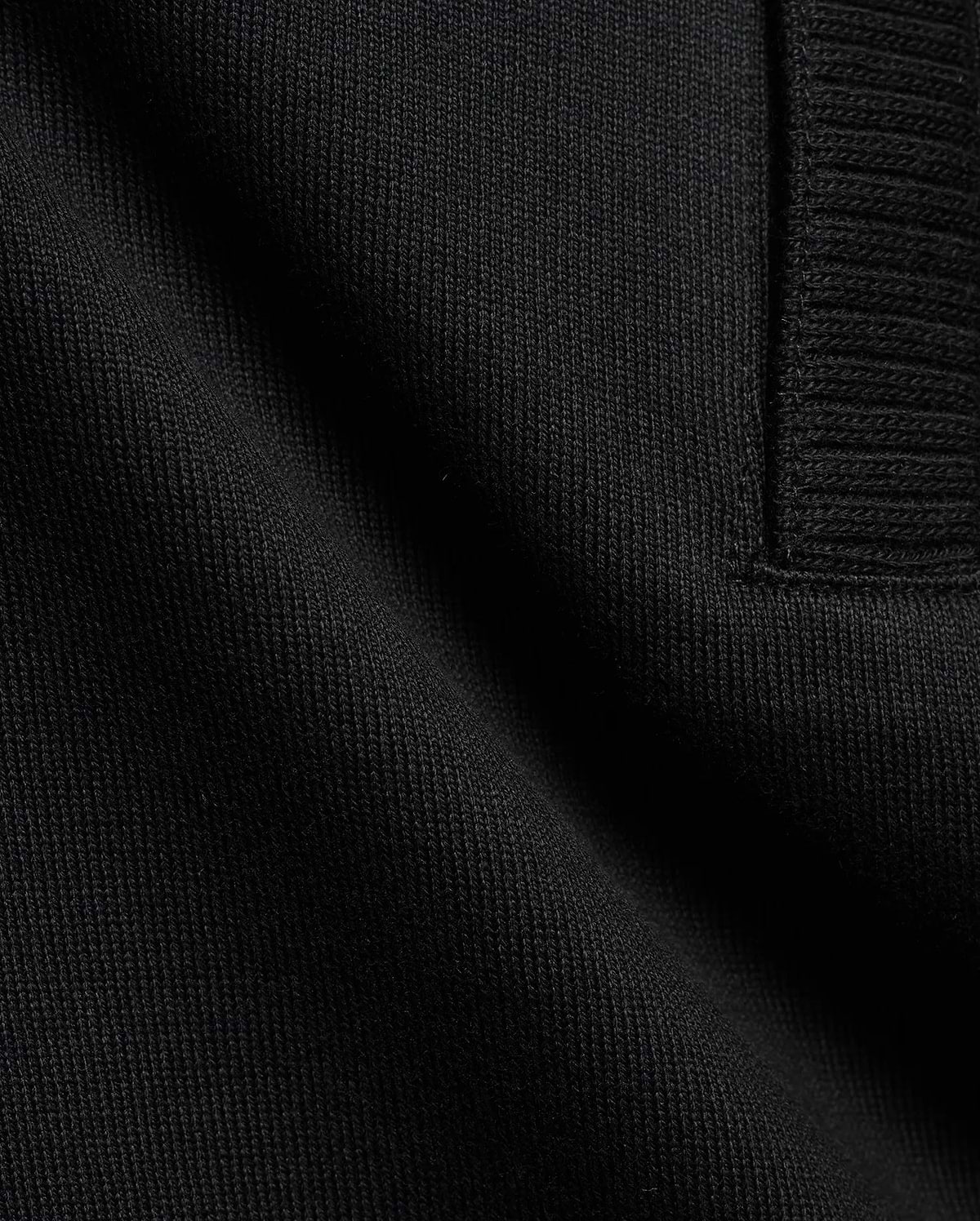 Men's Nolen Oversized Jersey Polo in rich black, highlighting its premium soft jersey knit fabric and a finely ribbed placket detail. (6)