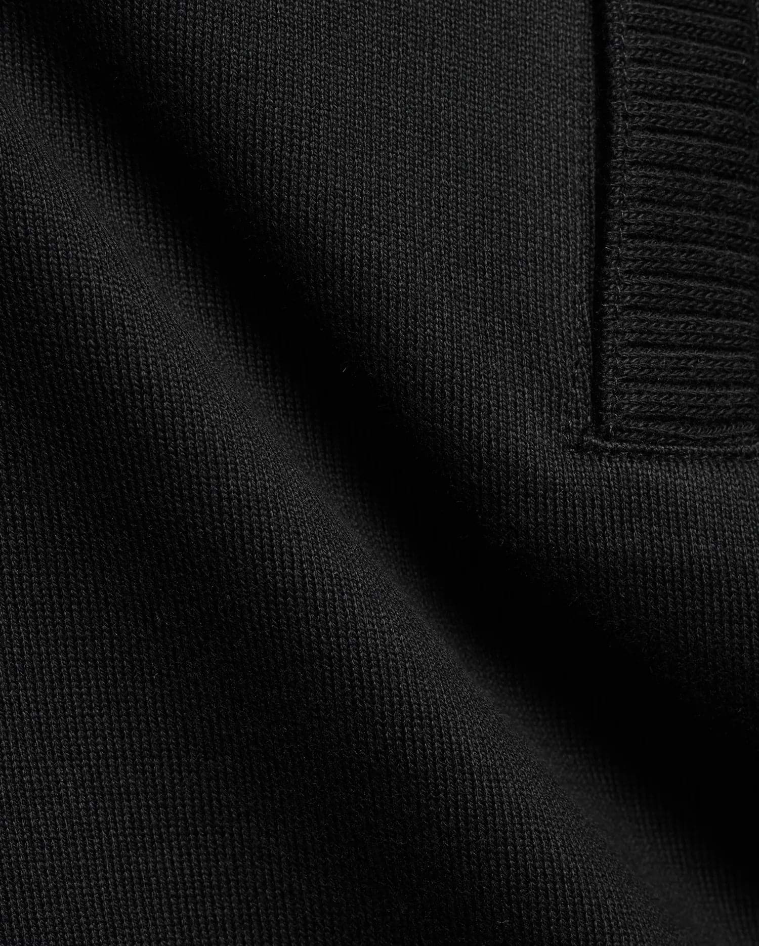 Men's Nolen Oversized Jersey Polo in rich black, highlighting its premium soft jersey knit fabric and a finely ribbed placket detail. (6)