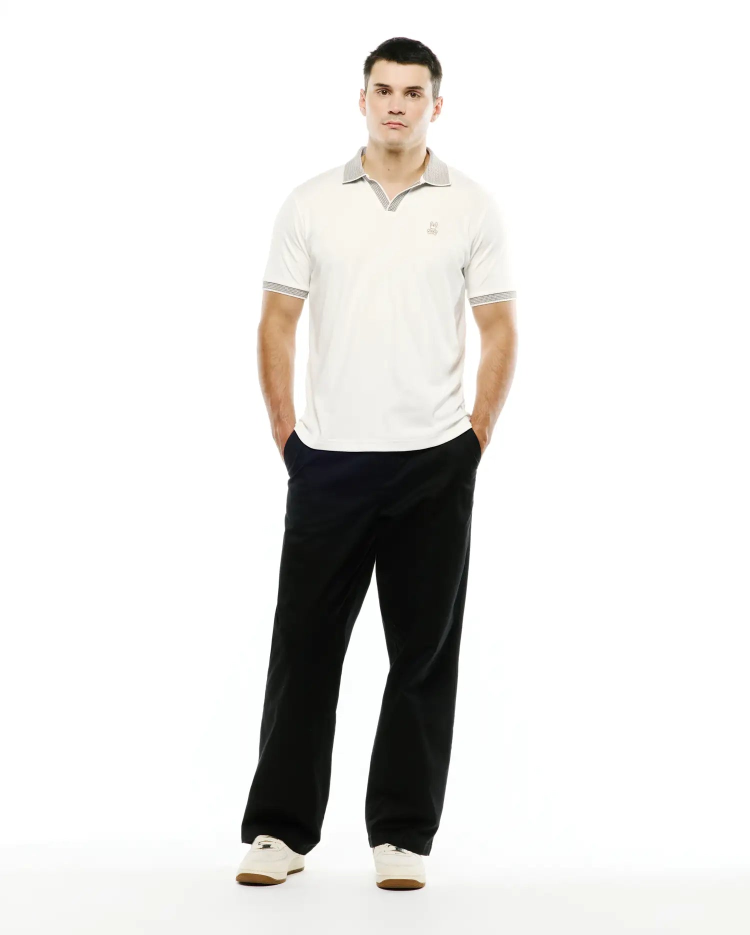 Men's Teddy Johnny Collar Polo, a classic fit off-white jersey polo with a grey patterned Johnny collar and matching sleeve cuffs, featuring a small embroidered Psycho Bunny skull logo on the left chest. (4)
