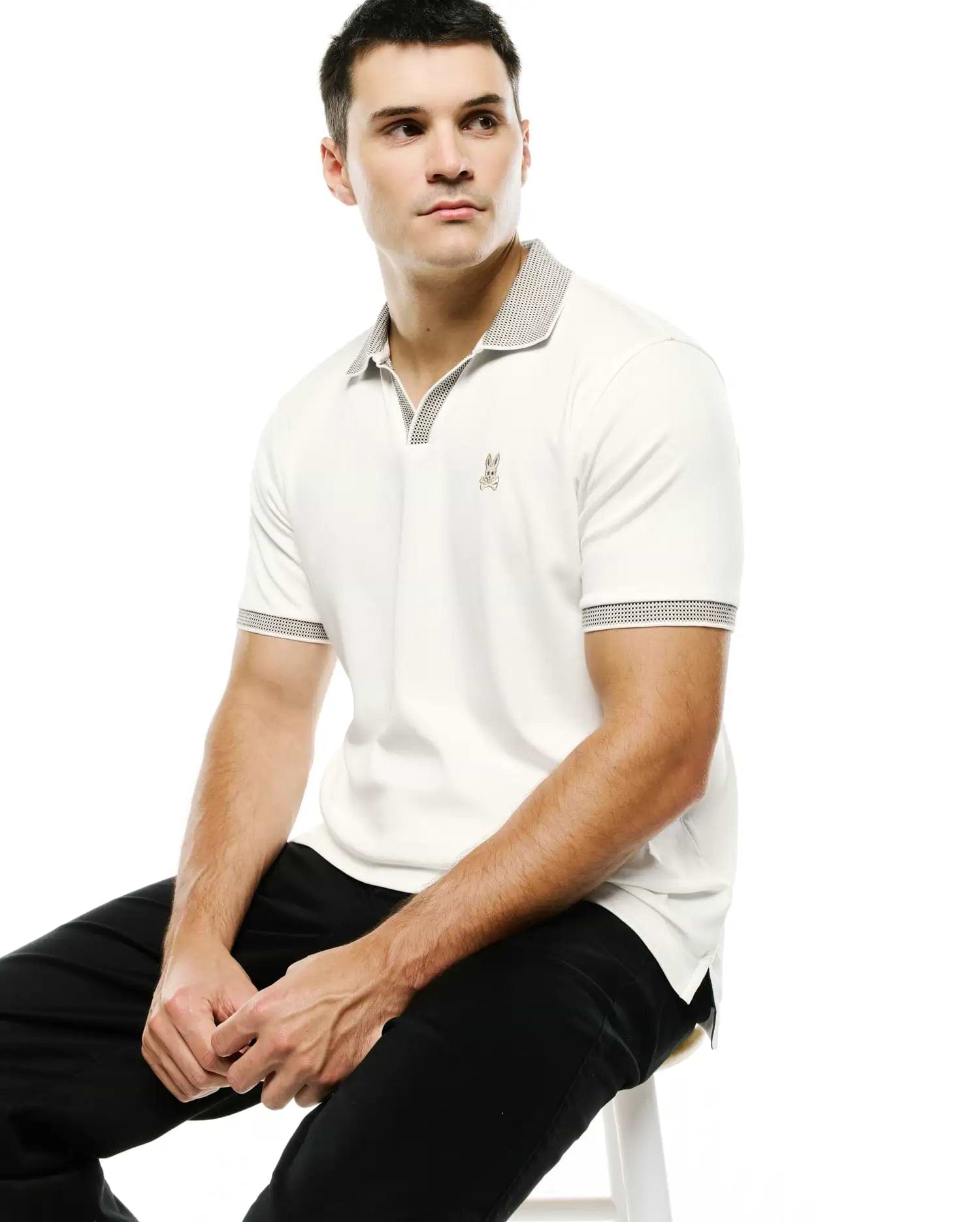 Men's Teddy Johnny Collar Polo, off-white classic fit pique polo with a black and white micro-dot patterned Johnny collar and sleeve cuffs, featuring a small embroidered Psycho Bunny skull logo on the left chest. (3)