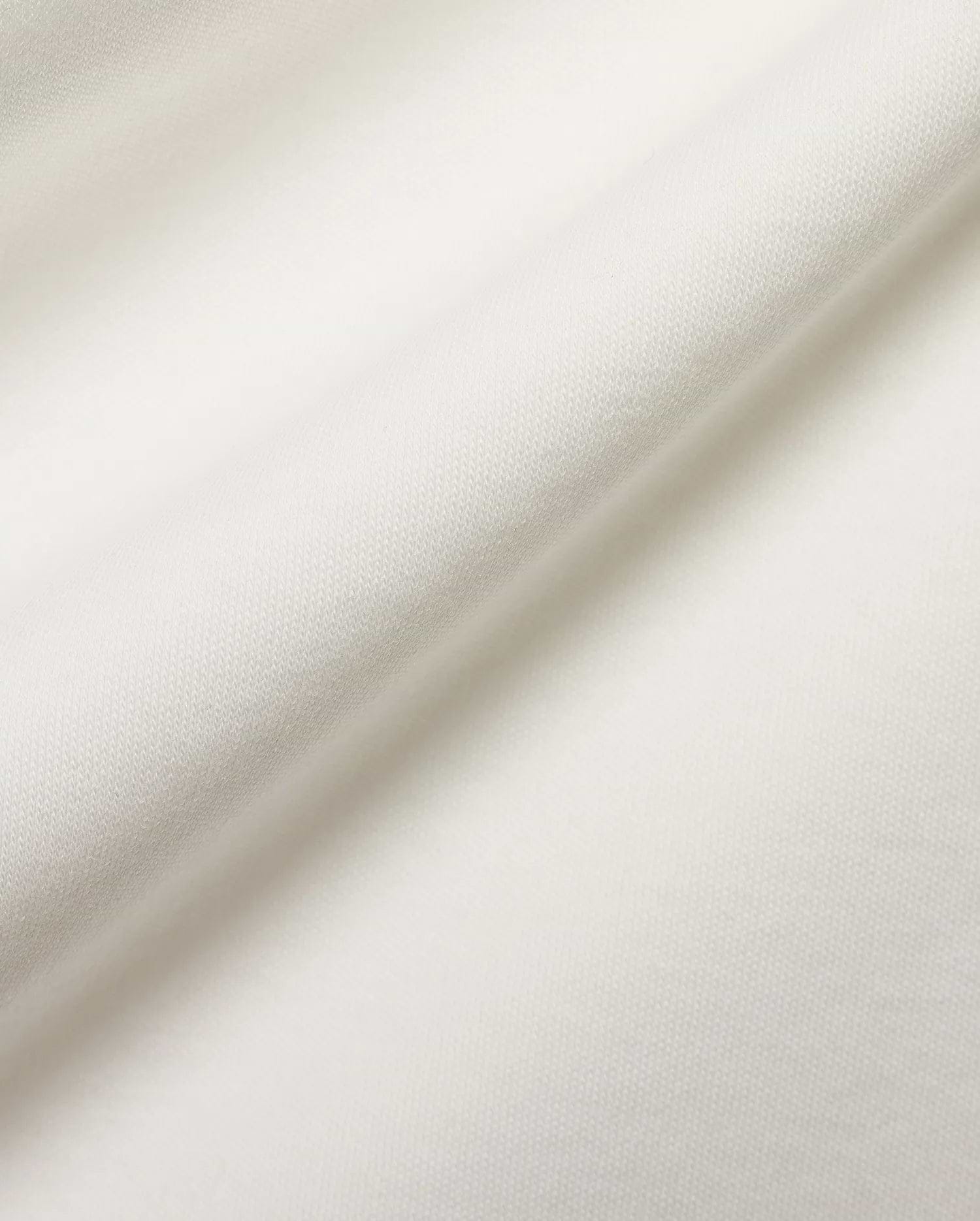 Crisp white pique fabric detail for the premium Psycho Bunny Men's Teddy Johnny Collar Polo, showcasing its refined texture and signature embroidered bunny skull logo. (6)