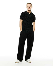 Men's Angus Flocked Polo: Black classic fit pique polo with a refined streetwear aesthetic, showcasing an all-over tonal flocked geometric bunny skull pattern and a two-button placket. (4)