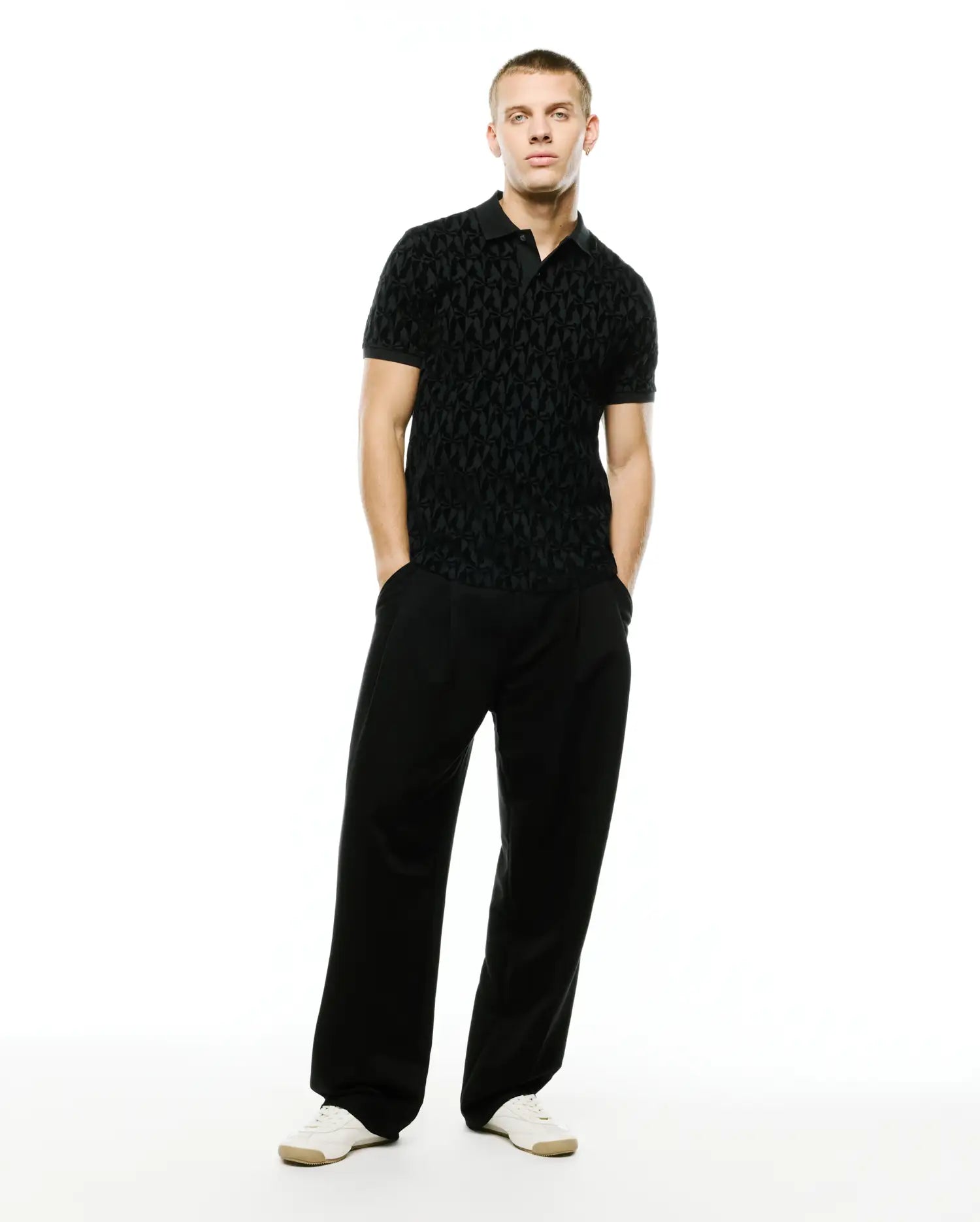 Men's Angus Flocked Polo: Black classic fit pique polo with a refined streetwear aesthetic, showcasing an all-over tonal flocked geometric bunny skull pattern and a two-button placket. (4)