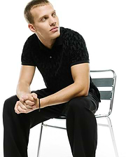Men's Angus Flocked Polo, a classic fit black polo shirt featuring a subtle, tonal black flocked geometric pattern throughout, providing a luxurious, soft texture. (3)