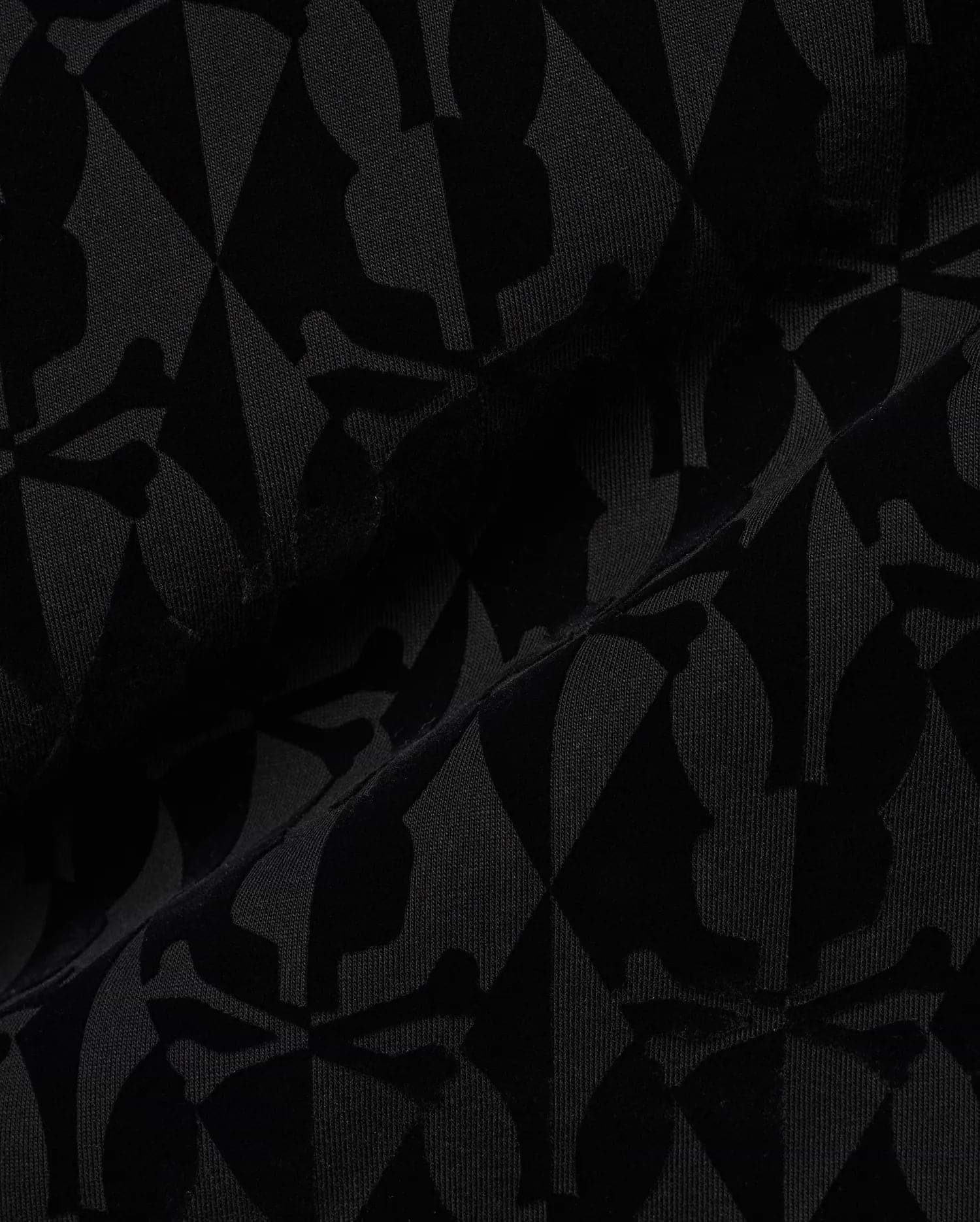 Men's Angus Flocked Polo featuring a tonal black flocked Psycho Bunny skull and crossbones and diamond pattern on a black pique knit fabric. (6)