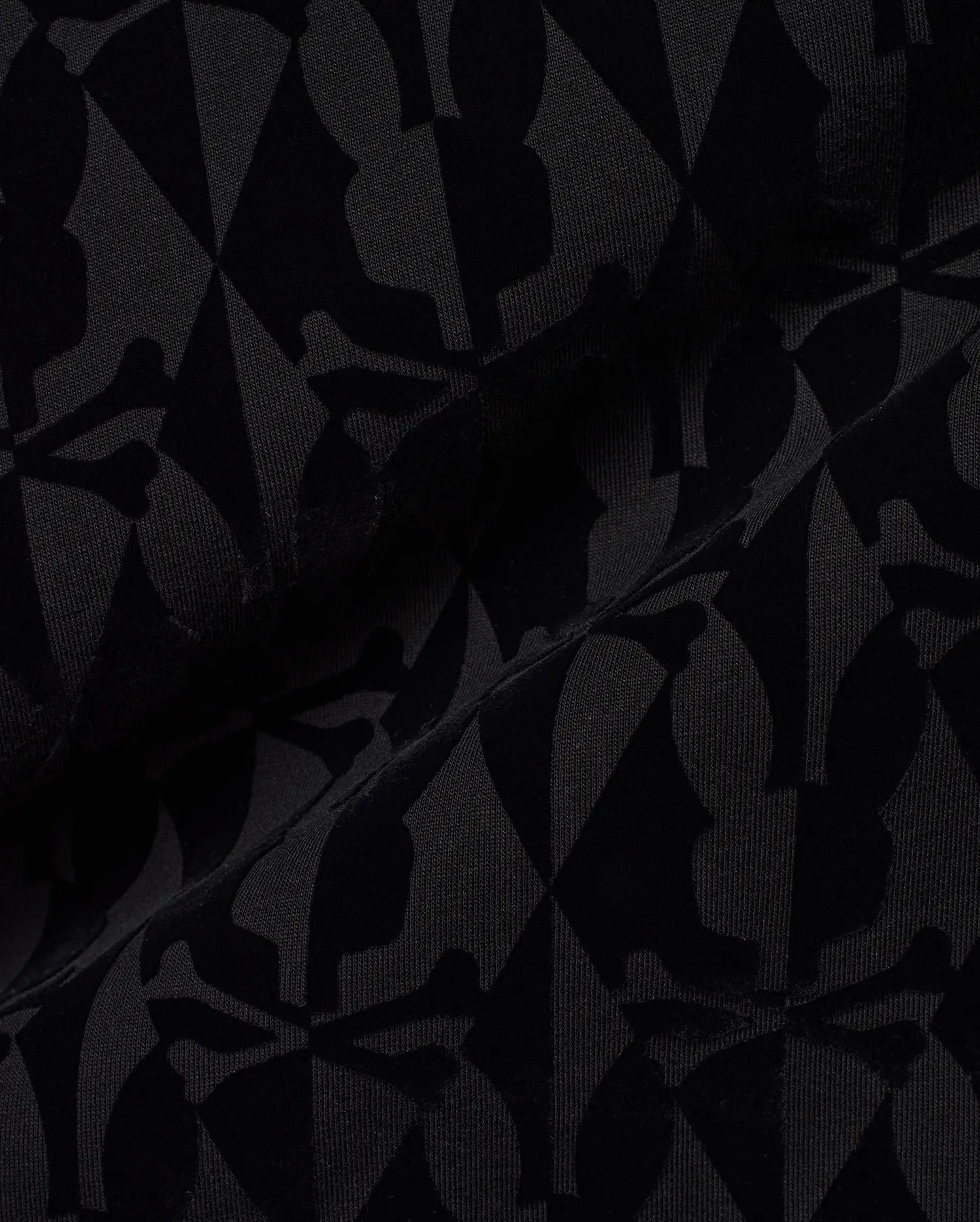 Men's Angus Flocked Polo featuring a tonal black flocked Psycho Bunny skull and crossbones and diamond pattern on a black pique knit fabric. (6)
