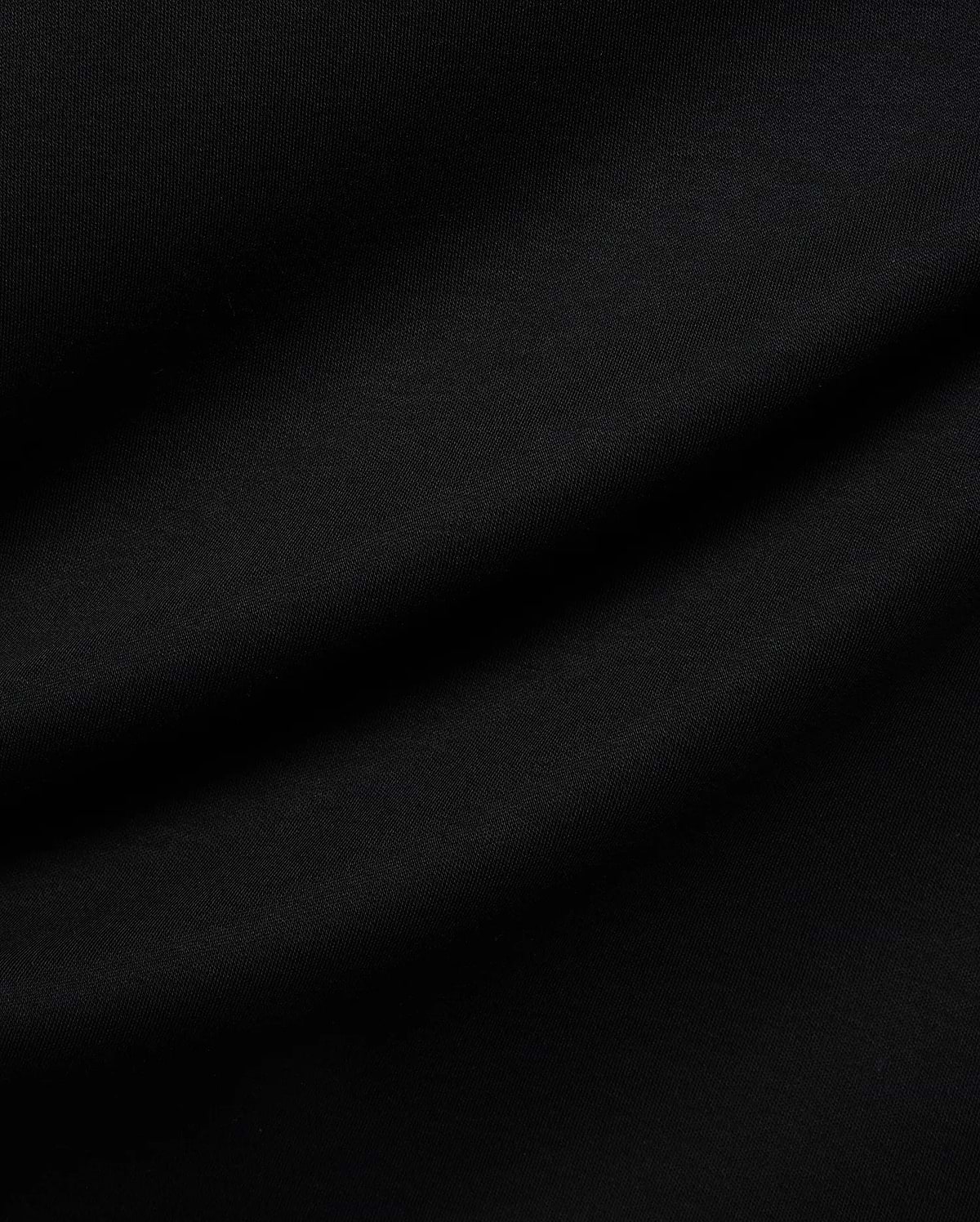 Mens Nasser Interlock Johnny Collar Polo in classic black, featuring smooth interlock fabric and the signature embroidered Psycho Bunny skull logo on the left chest.
