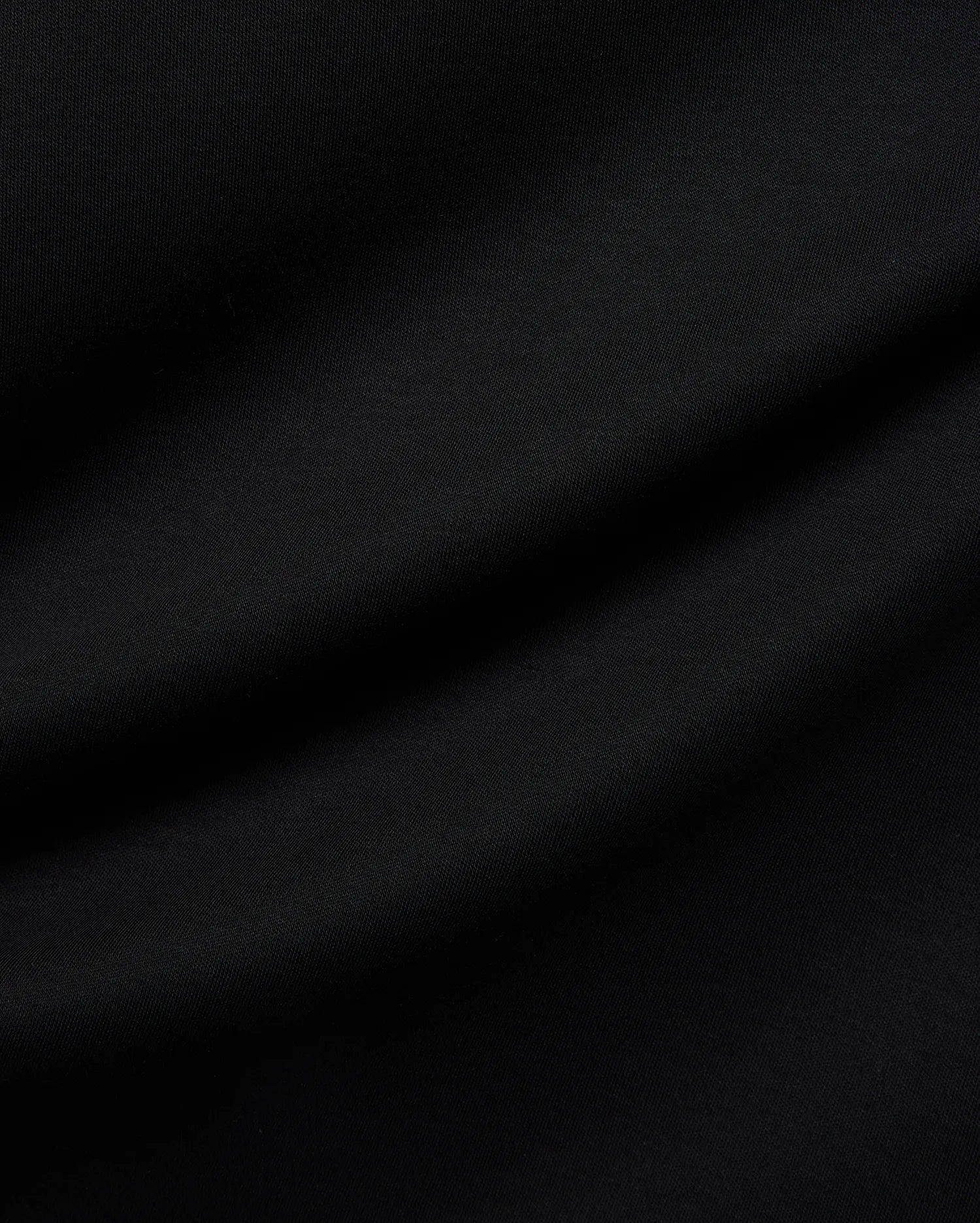 Mens Nasser Interlock Johnny Collar Polo in classic black, featuring smooth interlock fabric and the signature embroidered Psycho Bunny skull logo on the left chest.