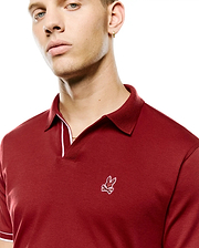Men's Nasser Johnny Collar Polo in deep red, with a pique collar, jersey body, white tipping on collar and sleeve cuffs, and an embroidered white Psycho Bunny skull logo on the left chest. (2)