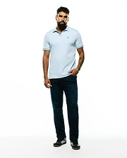 Mens Nasser Pima Johnny Polo, a light blue classic fit pique polo with an embroidered Psycho Bunny skull logo on the left chest and navy tipping on the collar and sleeve cuffs.