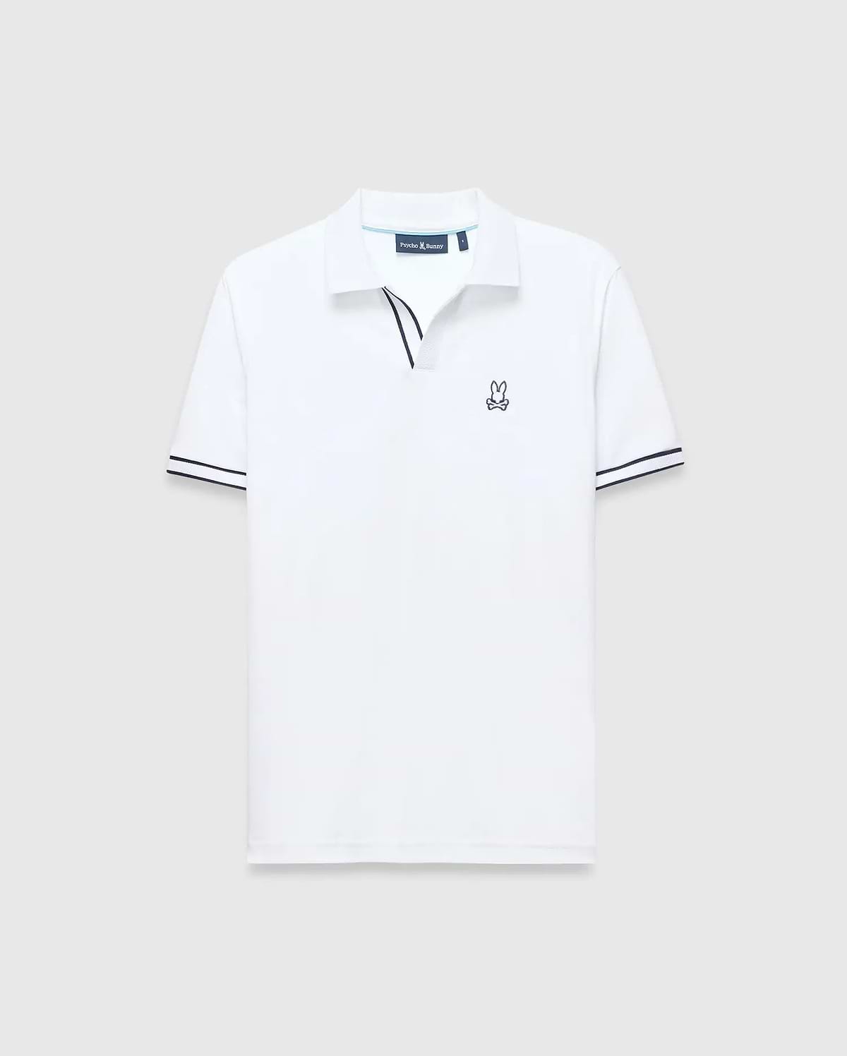 White Mens Nasser Polo, classic fit pique knit, with navy blue contrast collar trim, double striped cuffs, and an embroidered Psycho Bunny skull logo on the left chest.