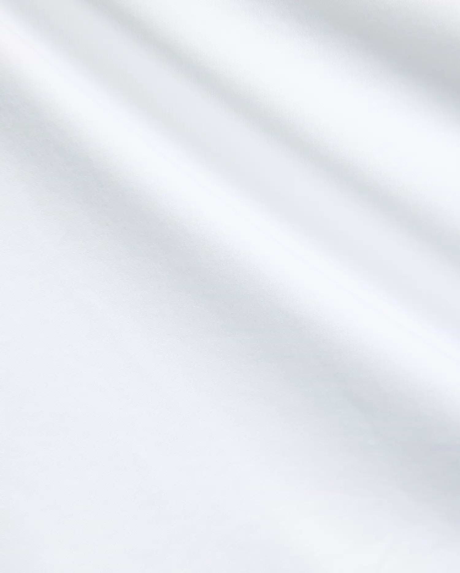 Mens Nasser Polo, classic fit white pique knit with a small embroidered Psycho Bunny skull logo on the left chest, embodying refined streetwear.