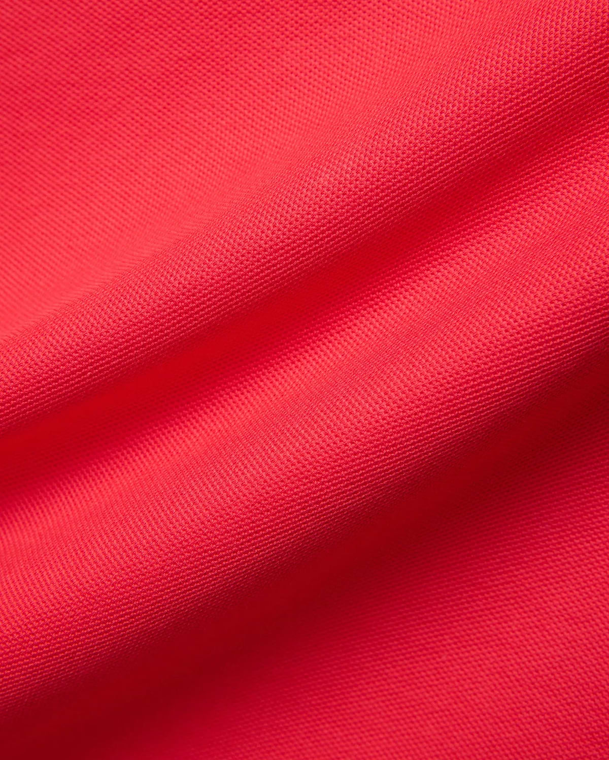 Mens Blythe Pique Polo in a rich, bold red, highlighting the refined, breathable pique fabric texture, a signature premium Psycho Bunny menswear piece.
