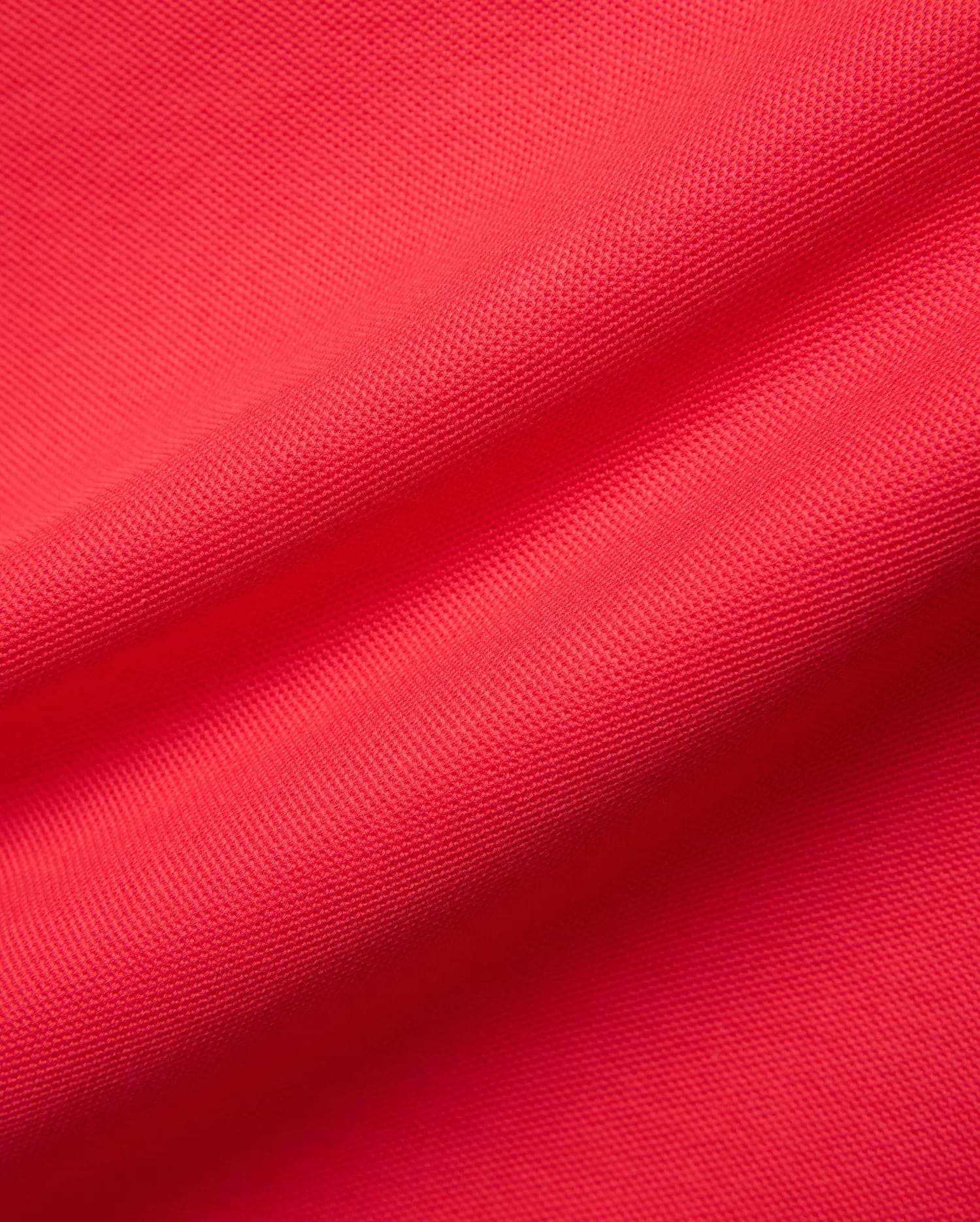 Mens Blythe Pique Polo in a rich, bold red, highlighting the refined, breathable pique fabric texture, a signature premium Psycho Bunny menswear piece.