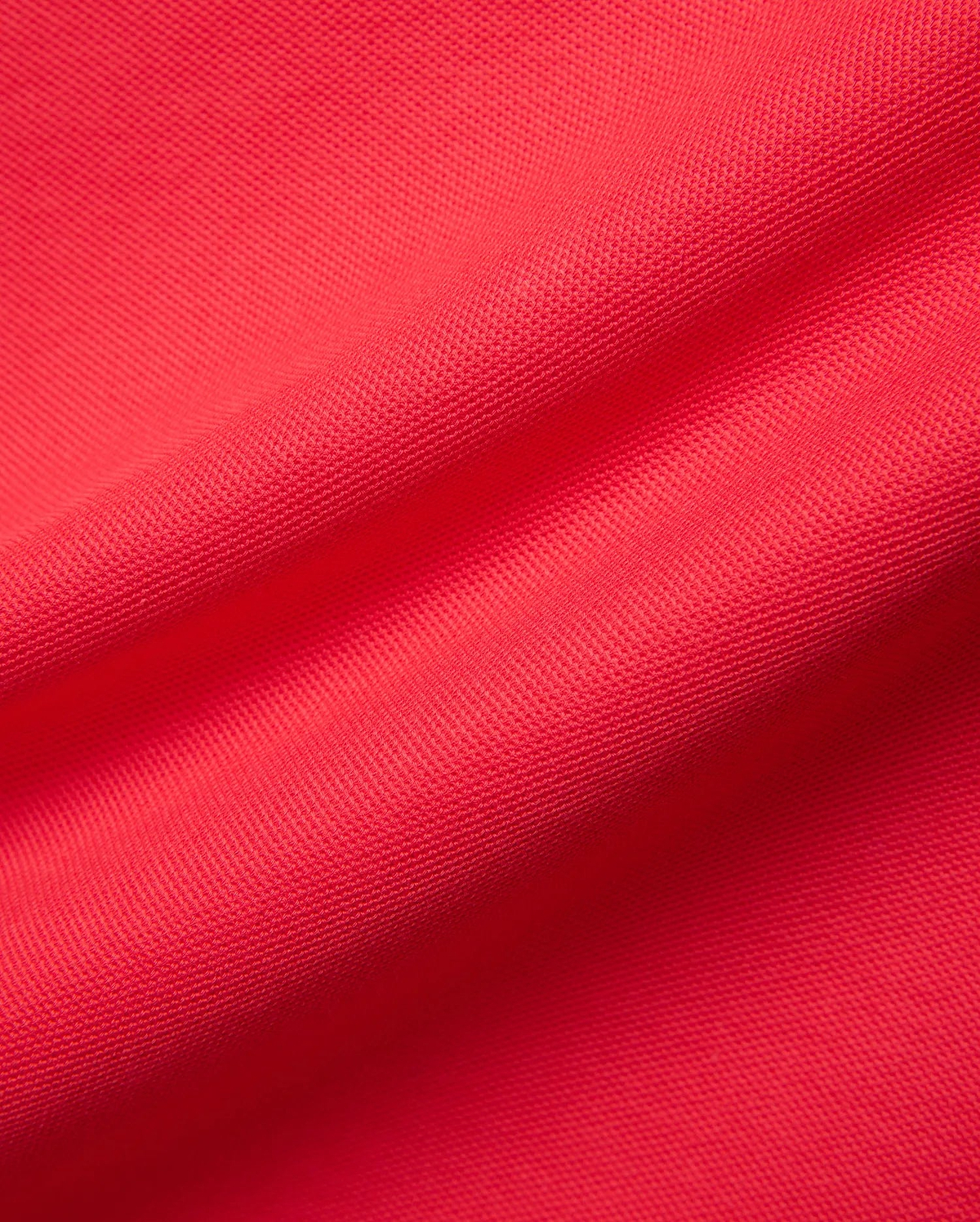 Mens Blythe Pique Polo in a rich, bold red, highlighting the refined, breathable pique fabric texture, a signature premium Psycho Bunny menswear piece.