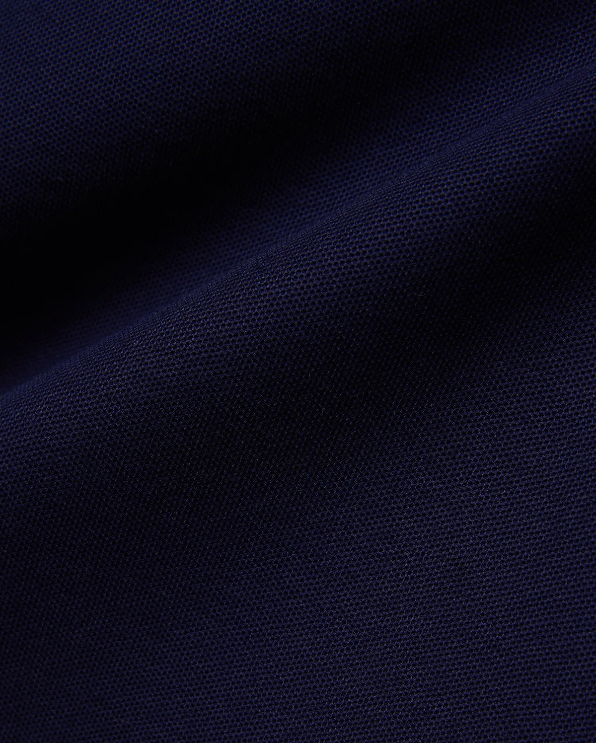 Deep navy Mens Blythe Pique Polo, featuring a classic fit, textured pique fabric, and the iconic small embroidered Psycho Bunny skull logo on the chest.