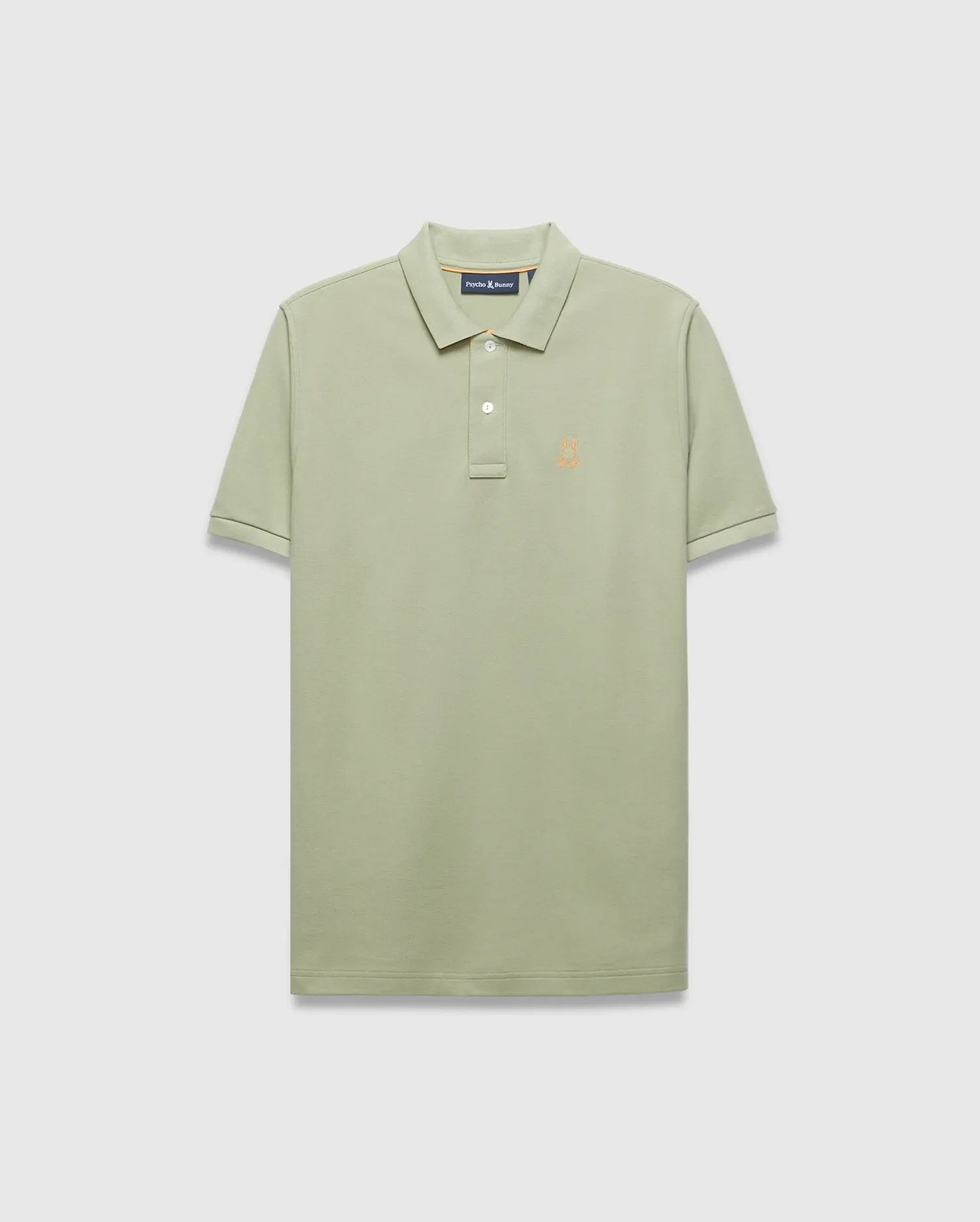 Mens Blythe Pique Polo in sage green, a classic fit polo with textured pique fabric, two-button placket, and a small embroidered orange Psycho Bunny skull logo on the left chest.