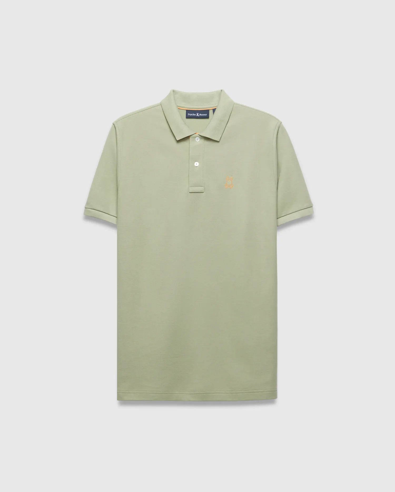 Mens Blythe Pique Polo in sage green, a classic fit polo with textured pique fabric, two-button placket, and a small embroidered orange Psycho Bunny skull logo on the left chest.
