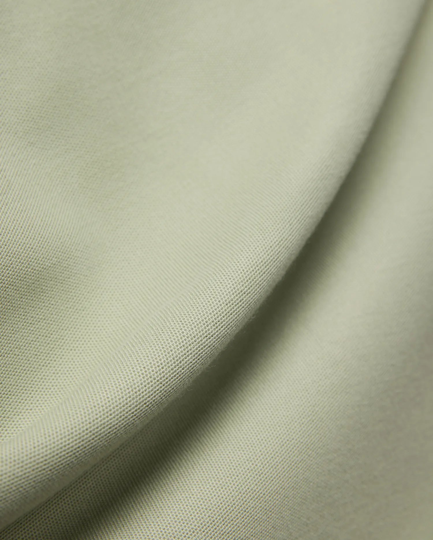MENS BLYTHE PIQUE POLO, featuring a luxurious, breathable light sage green pique fabric with a distinctive textured weave, reflecting Psycho Bunny's premium menswear quality.