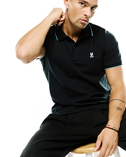 Men's Klaus Pique Polo, a classic fit black pique polo with light blue contrast tipping on the collar and sleeves, featuring a small embroidered white Psycho Bunny skull logo on the left chest. (3)
