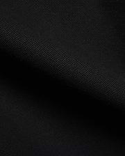 Detailed close-up of a rich black pique fabric, revealing the distinctive textured weave of the premium Men's Klaus Pique Polo, a signature Psycho Bunny menswear piece. (6)