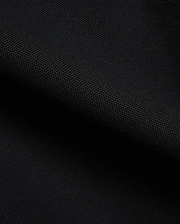 Detailed close-up of a rich black pique fabric, revealing the distinctive textured weave of the premium Men's Klaus Pique Polo, a signature Psycho Bunny menswear piece. (6)