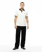 Men's Klaus Pique Polo in off-white, featuring a navy blue collar, light blue and navy striped ribbed cuffs, and a small embroidered Psycho Bunny skull logo on the left chest. (4)
