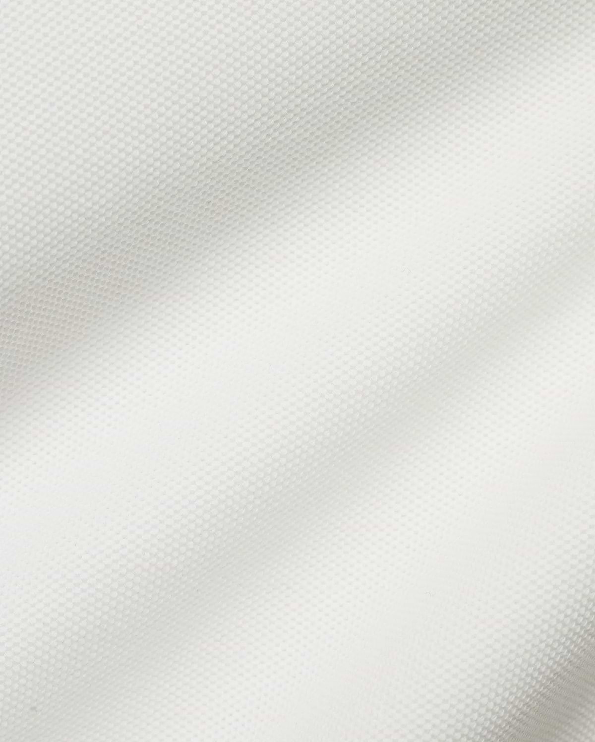 Crisp white Men's Klaus Pique Polo, crafted from premium textured pique fabric, featuring the iconic small embroidered Psycho Bunny skull logo on the left chest for refined streetwear style. (6)