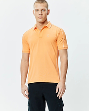 Mens Rhys Sport Polo, vibrant orange smooth performance jersey with white piping on shoulders and sides, classic fit, and small embroidered Psycho Bunny skull logo on left chest.