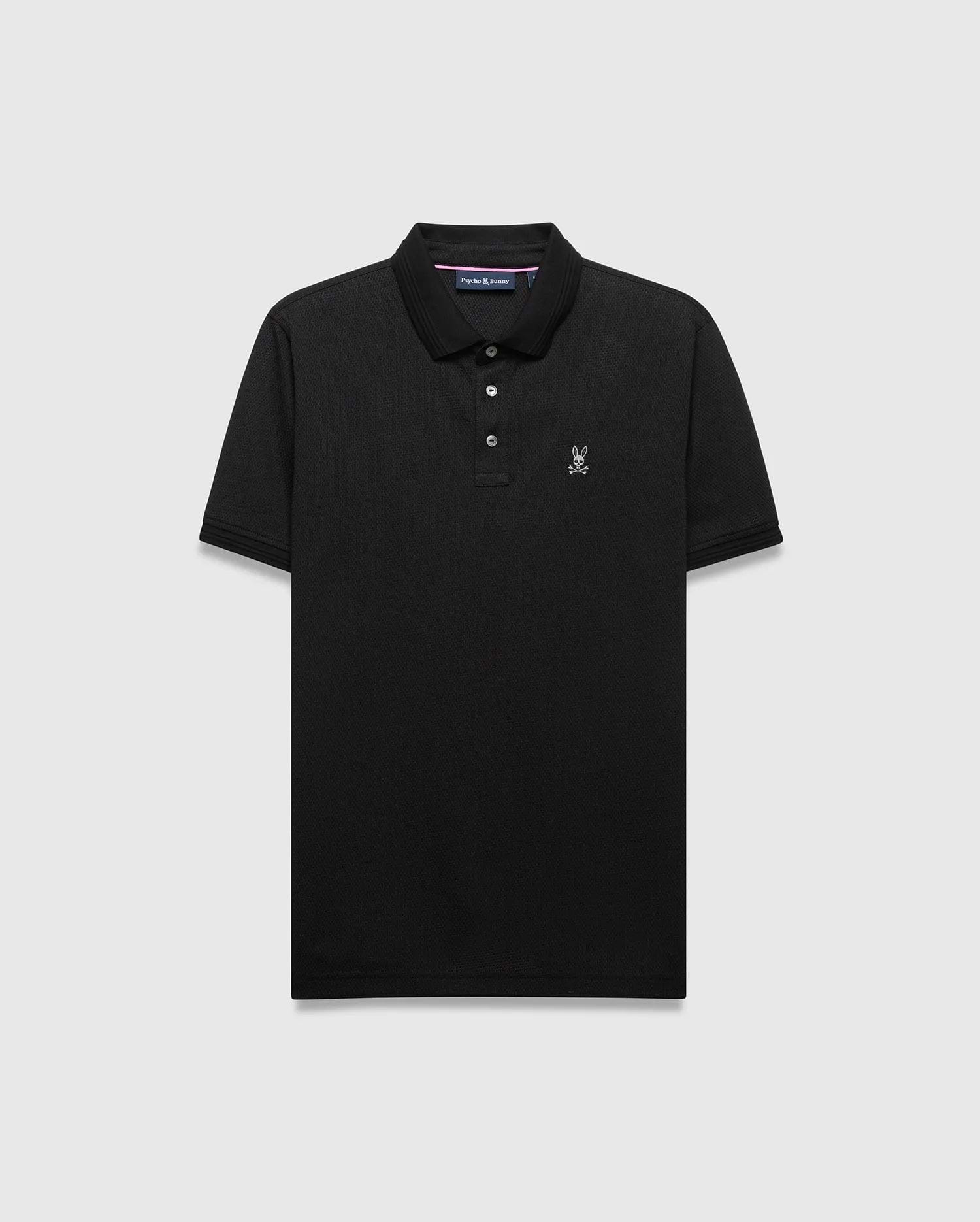 Mens Tiernan Pique Polo in black, classic fit, with a pique knit texture. Features a small white embroidered Psycho Bunny skull logo on the left chest, a three-button placket, and ribbed cuffs.