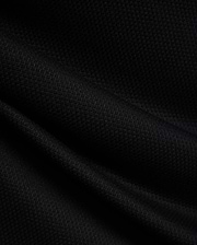 MENS TIERNAN PIQUE POLO in deep black, showcasing its premium, classic textured pique knit fabric with elegant folds, reflecting Psycho Bunny's refined streetwear aesthetic.