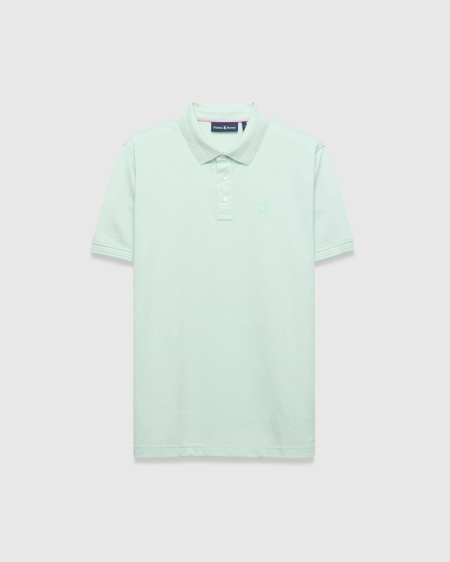 Mens Tiernan Pique Polo in mint green, featuring a classic fit, pique knit texture, ribbed collar and cuffs with subtle stripe detail, three white button placket, and a small tonal embroidered Psycho Bunny skull logo on the left chest.