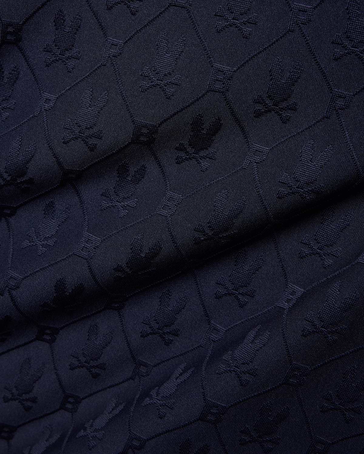 Mens Garry Jacquard Johnny Collar Polo in dark navy, featuring an all-over tone-on-tone jacquard knit pattern of the iconic Psycho Bunny skull logo within hexagonal shapes. (7)